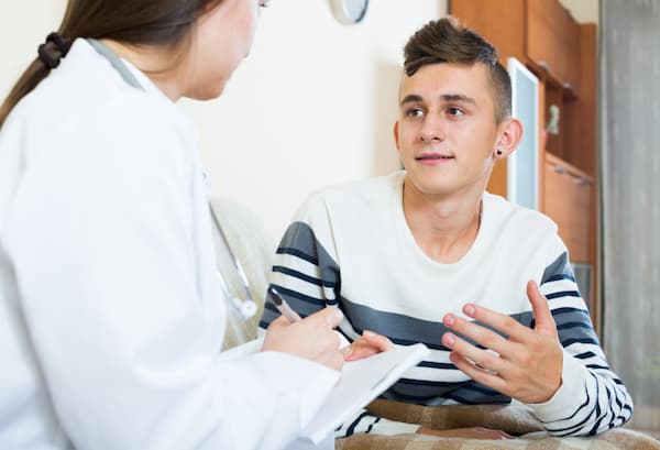 Teen talking with doctor