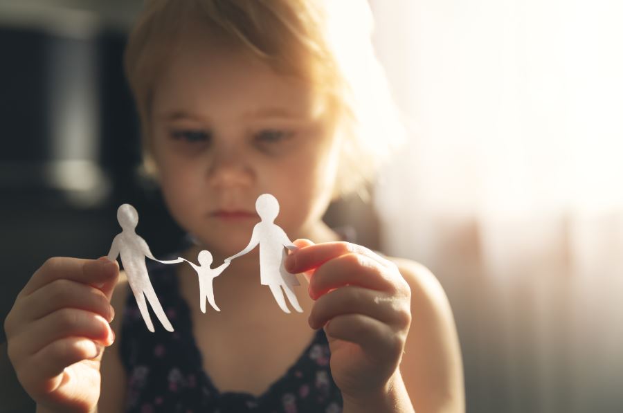 child looking at paper cut out of family