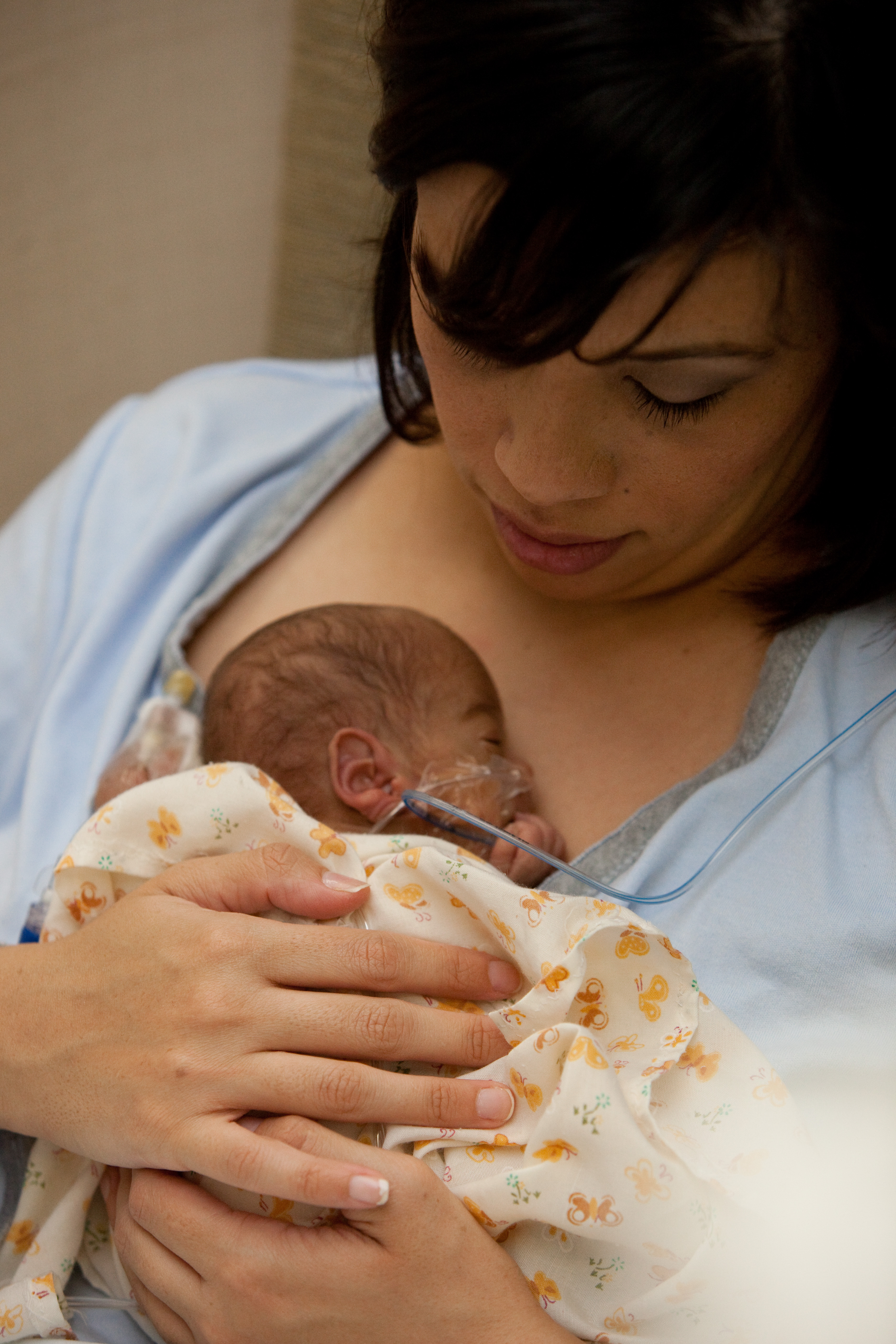 Mother holding baby in NICU