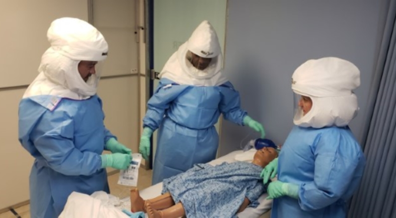 Three doctors in protective gear training